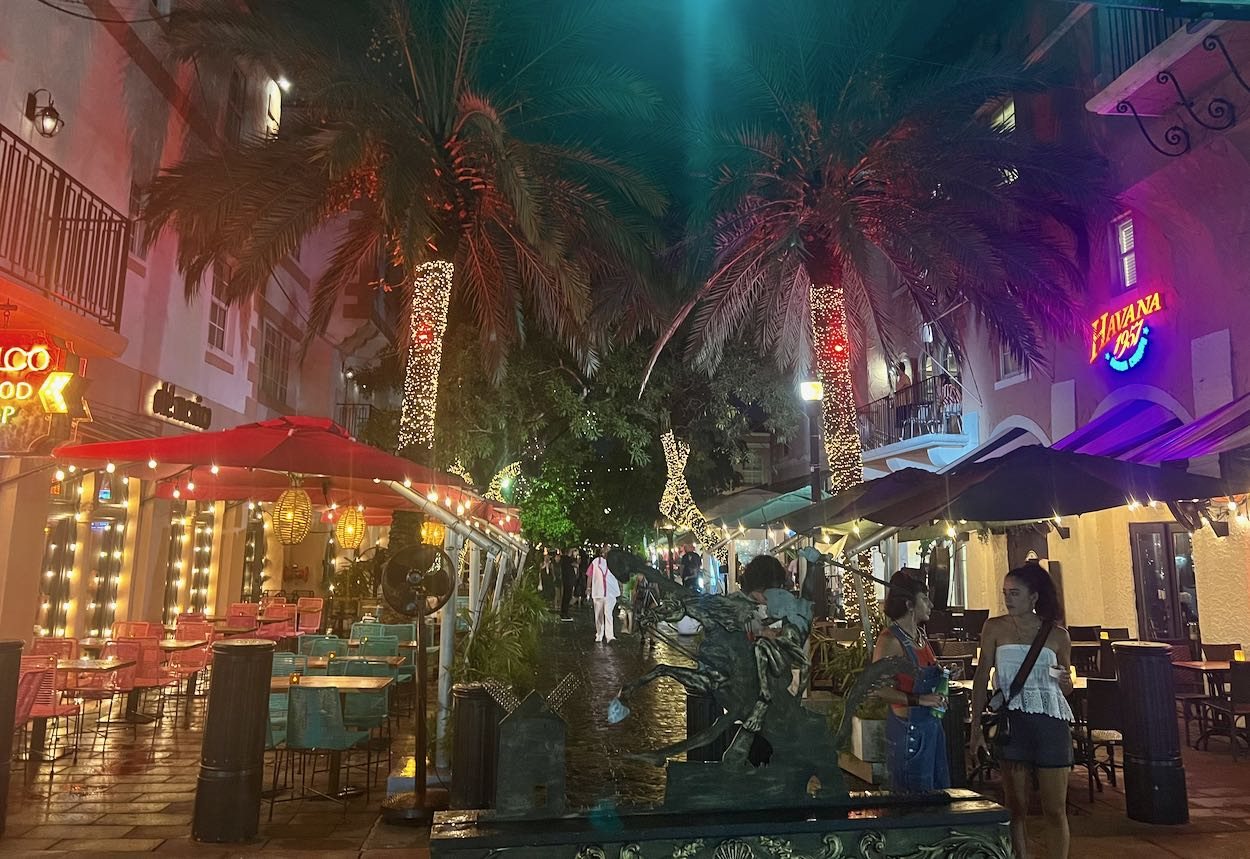 Española Way at night with lit palm trees, patios and the Havana 1957 neon sign in South Beach