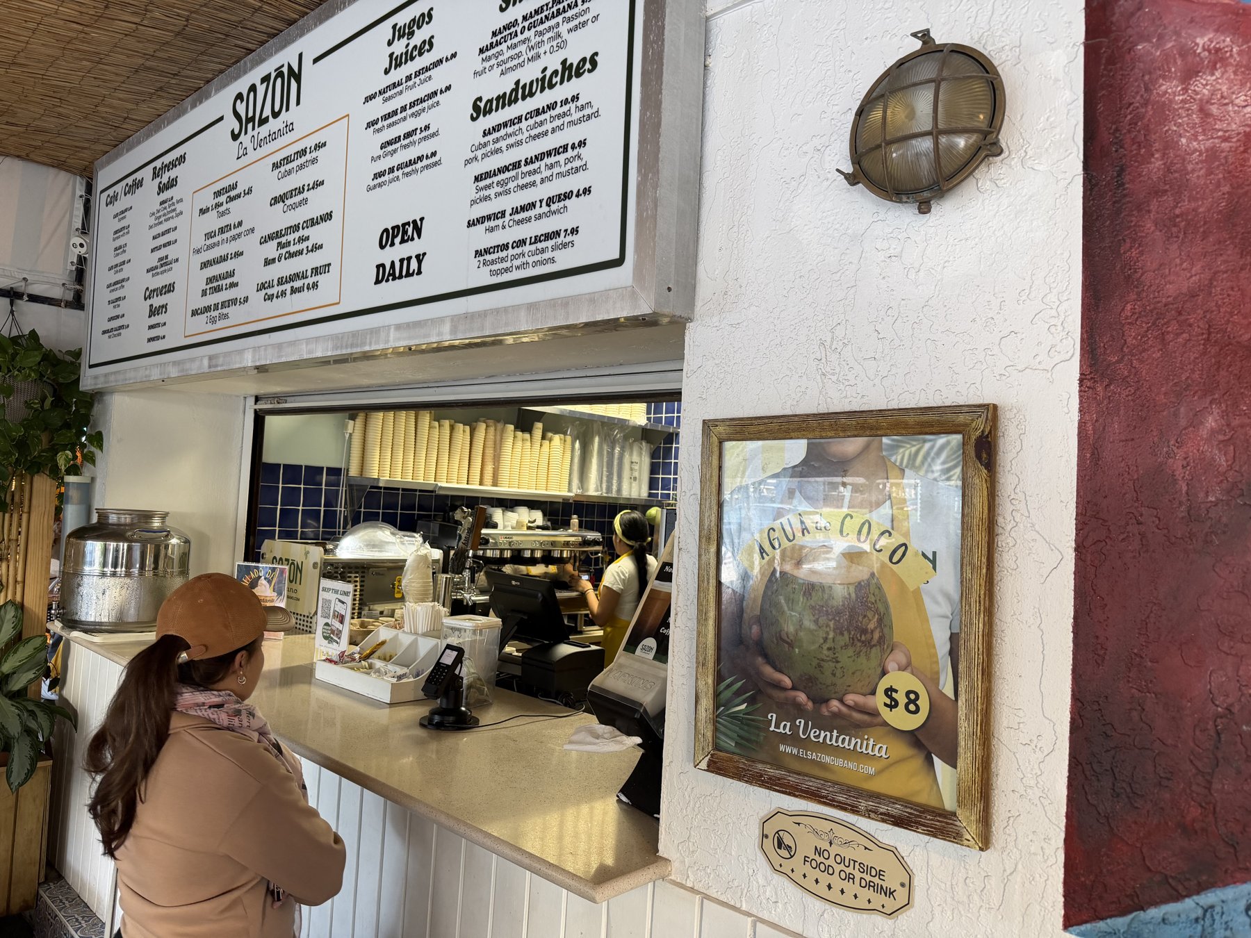 Sazón walk-up window in North Beach with menu of Cuban coffee, juices and Cuban sandwich